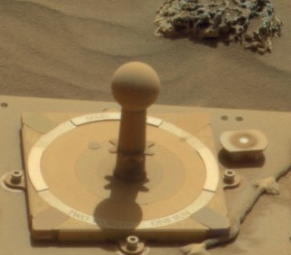 MarsDial on the Spirit rover on Mars, with a shadow cast by the gnomon.